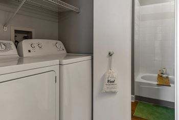 a laundry room with a washer and dryer and a sink at The Pointe at St. Joseph Apartments, South Bend, IN, 46617